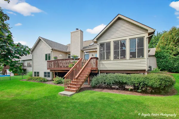 a view of outdoor sitting area with swimming pool and trees in the background