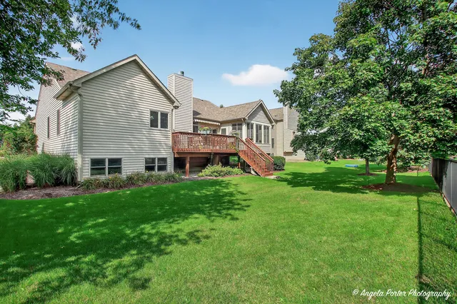 a front view of a building with garden and seating area
