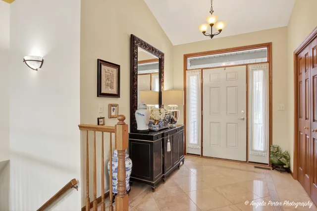 a living room with furniture a flat screen tv and a refrigerator