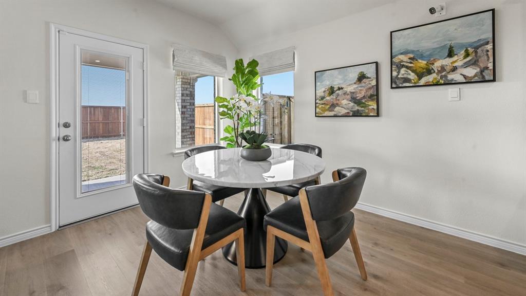 4020 Red Blf Street Pilot Point, TX 76258 - Photo 35 of 39 a view of a dining room with furniture window and wooden floor