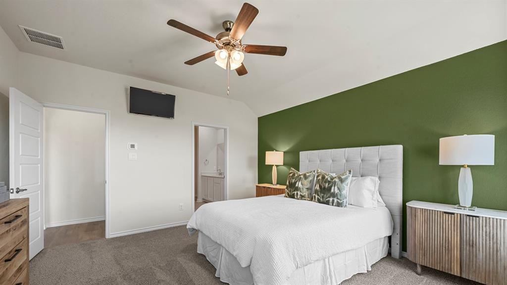 4020 Red Blf Street Pilot Point, TX 76258 - Photo 7 of 39 a bedroom with a large bed and a chandelier