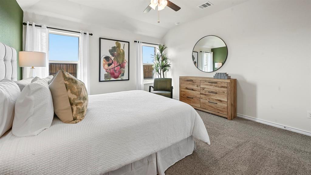 4020 Red Blf Street Pilot Point, TX 76258 - Photo 9 of 39 a bedroom with a bed and a chandelier