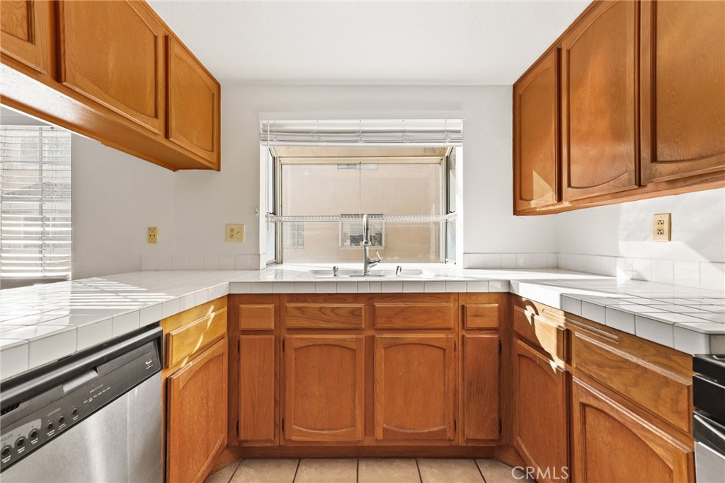 2300 Maple Avenue, Unit 26 Torrance, CA 90503 - Photo 14 of 24 a kitchen with stainless steel appliances granite countertop a sink and cabinets