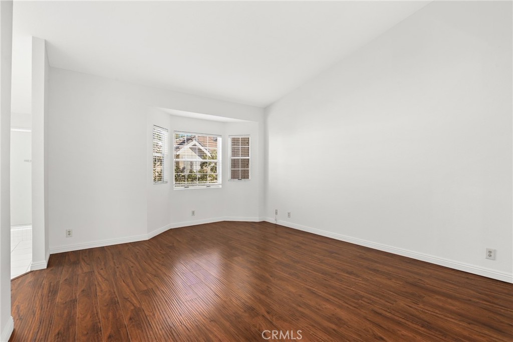 2300 Maple Avenue, Unit 26 Torrance, CA 90503 - Photo 15 of 30 an empty room with wooden floor and windows