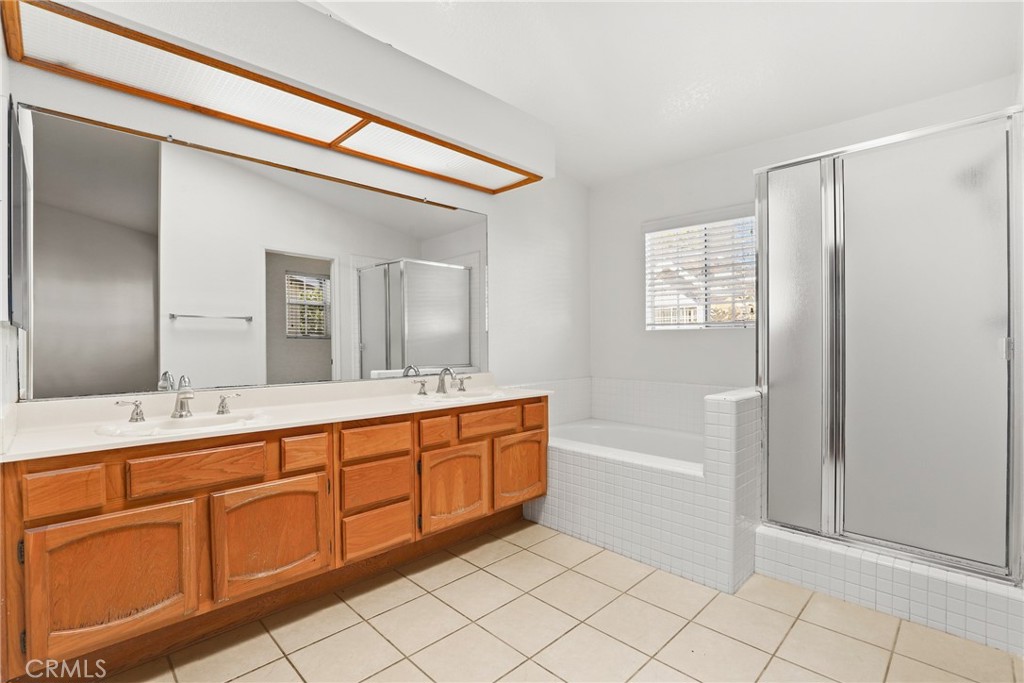 2300 Maple Avenue, Unit 26 Torrance, CA 90503 - Photo 18 of 24 a spacious bathroom with a mirror a shower and a sink
