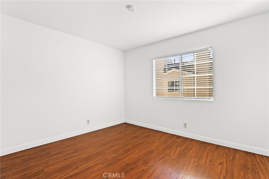2300 Maple Avenue, Unit 26 Torrance, CA 90503 - Photo 22 of 24 an empty room with wooden floor and windows