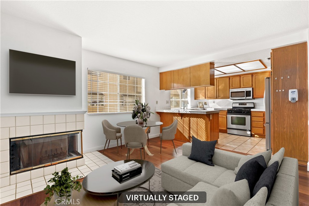 2300 Maple Avenue, Unit 26 Torrance, CA 90503 - Photo 7 of 24 a living room with furniture a flat screen tv and a fireplace