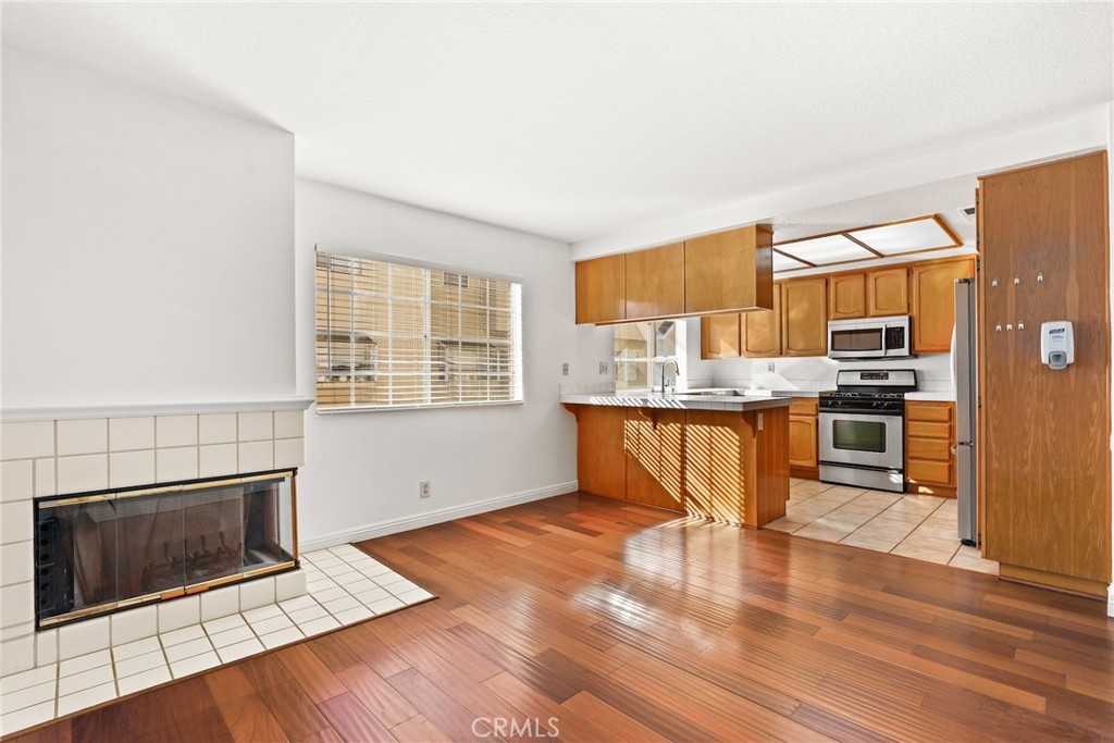 2300 Maple Avenue, Unit 26 Torrance, CA 90503 - Photo 8 of 30 a kitchen with stainless steel appliances granite countertop a stove a sink and a microwave