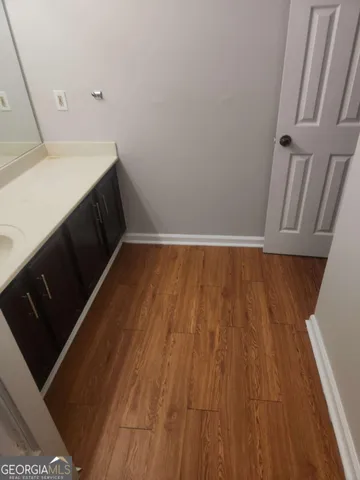 a view of storage and utility room with wooden floor
