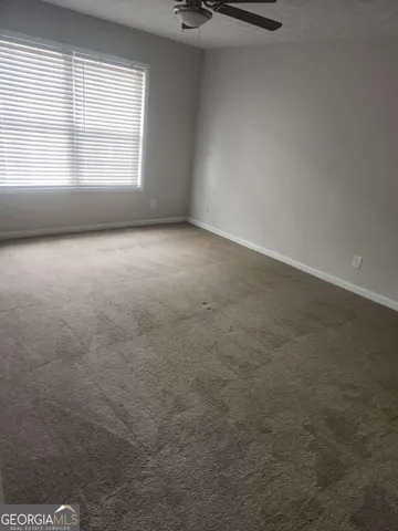 an empty room with a empty space and windows