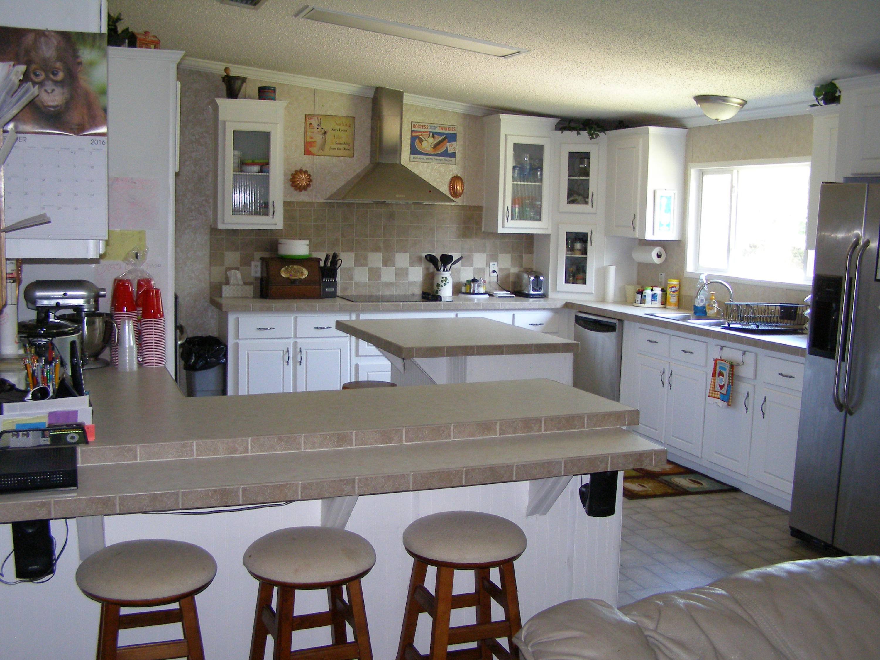 1121 State Line Road Baker, FL 32531 - Photo 12 of 25 a large kitchen with a table and chairs in it