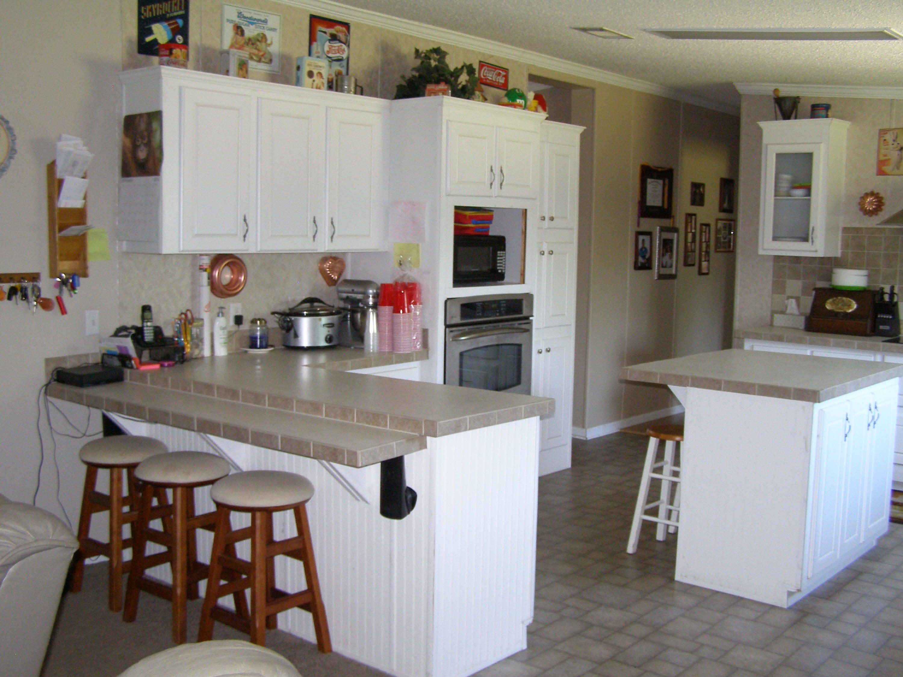 1121 State Line Road Baker, FL 32531 - Photo 13 of 25 a kitchen with stainless steel appliances granite countertop a sink and a refrigerator