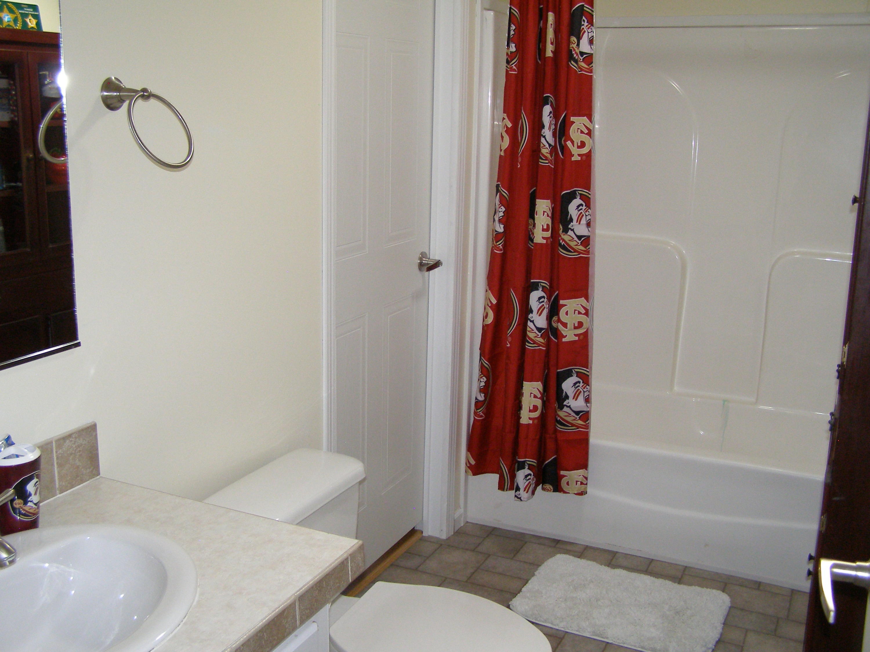 1121 State Line Road Baker, FL 32531 - Photo 18 of 25 a bathroom with a sink toilet and shower