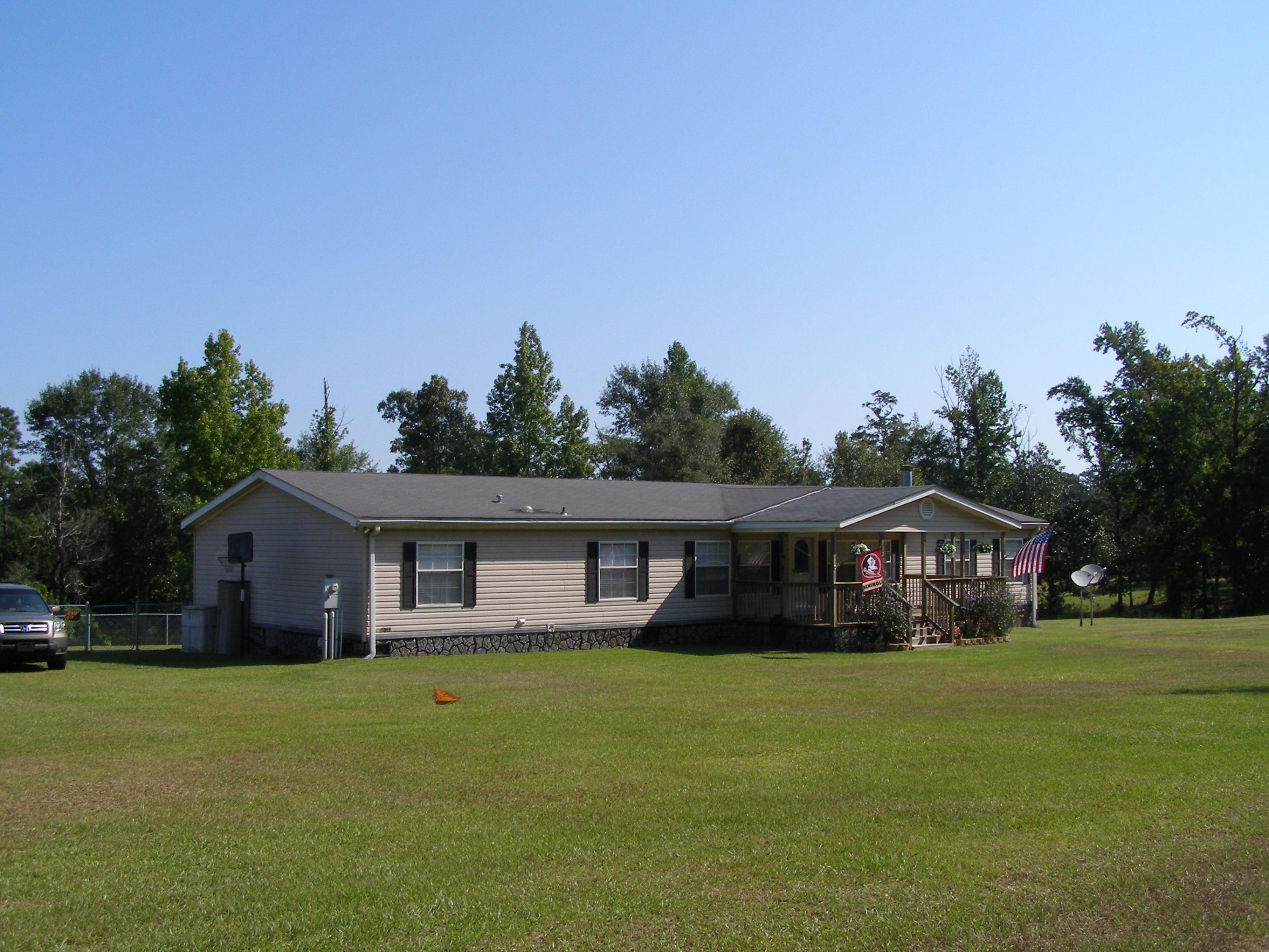 1121 State Line Road Baker, FL 32531 - Photo 2 of 25 a front view of house with yard outdoor seating and green space
