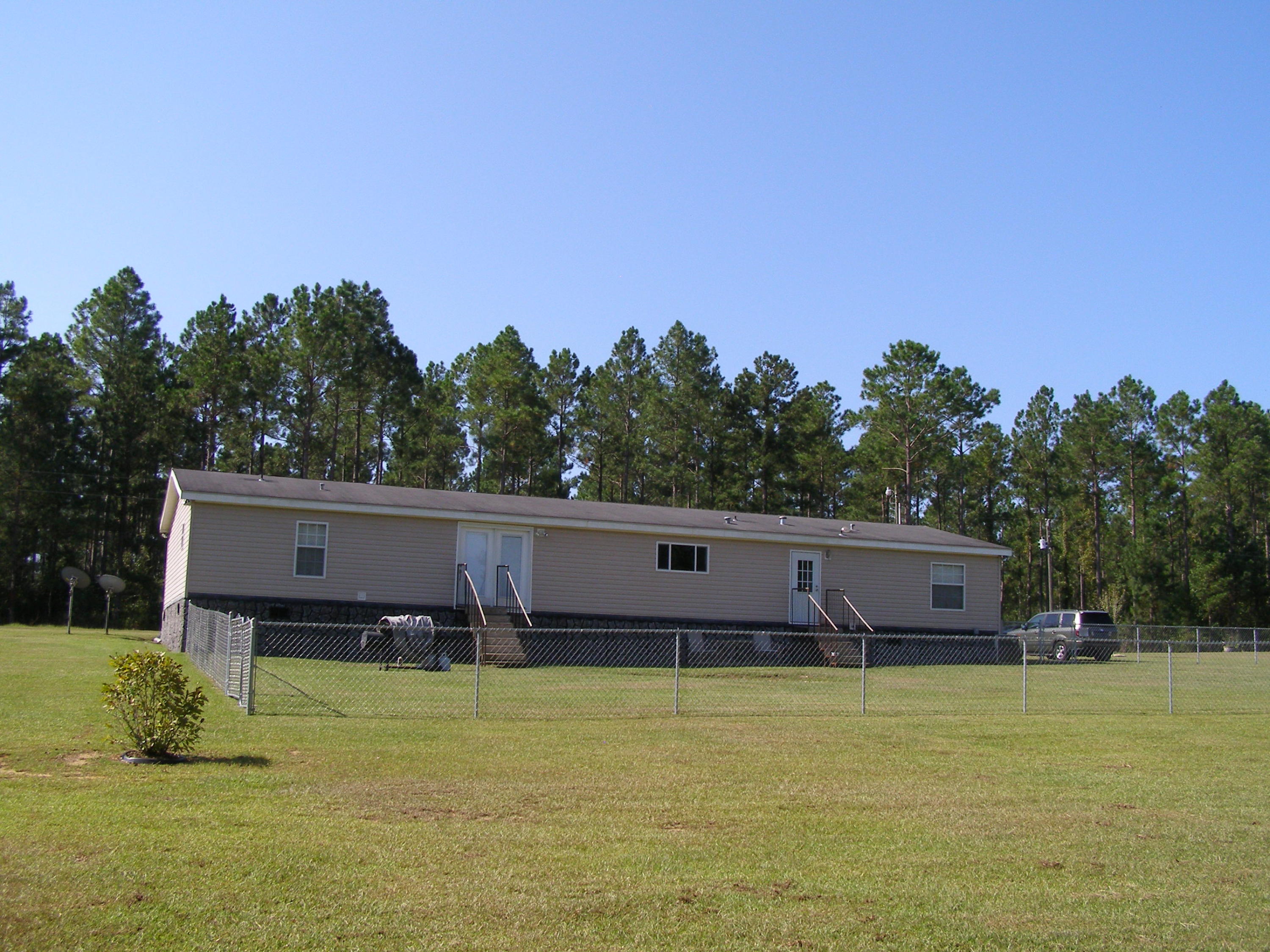 1121 State Line Road Baker, FL 32531 - Photo 5 of 25 a view of a house with a yard