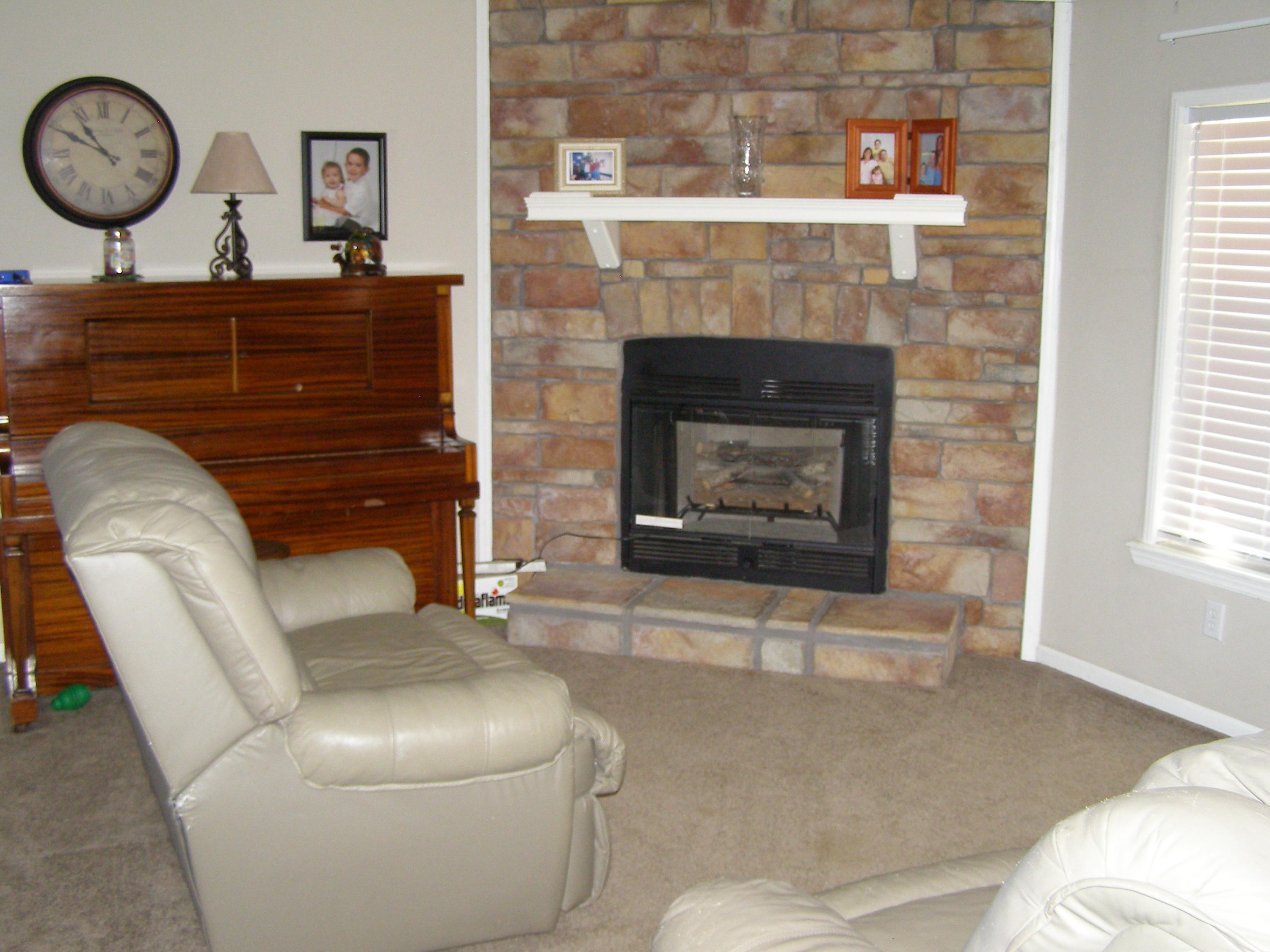 1121 State Line Road Baker, FL 32531 - Photo 9 of 25 a living room with furniture and a fireplace