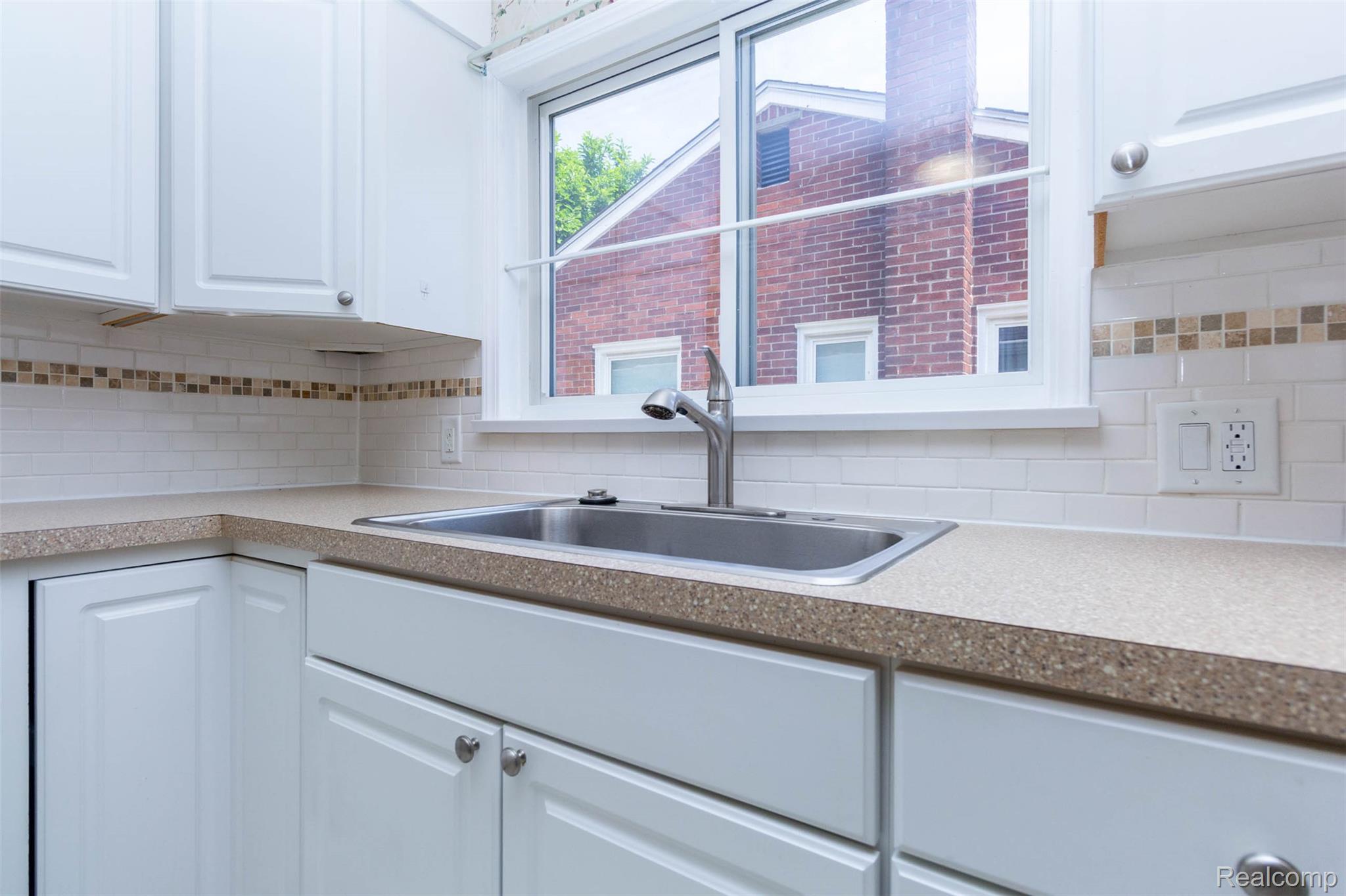 14869 Champaign Road Allen Park, MI 48101 - Photo 13 of 34 Kitchen sink area featuring a stainless steel sink, a single-handle faucet, and a large window