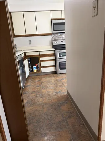 a kitchen with a stove microwave and sink