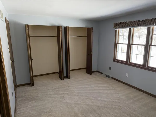 an empty room with closet area