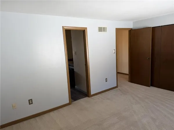 a view of a hallway with a door and a room