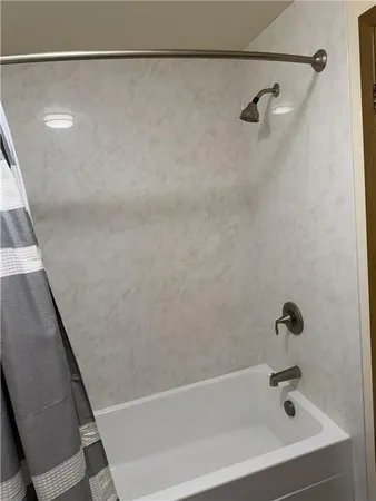 a white toilet sitting next to a shower