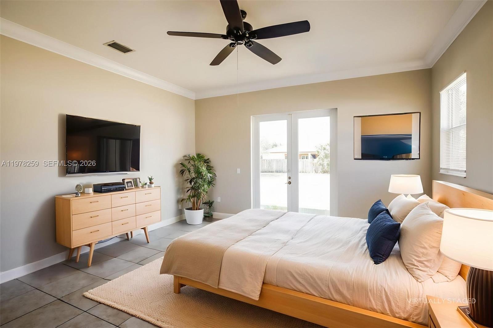 18686 Southwest 132nd Avenue Miami, FL 33177 - Photo 11 of 18 a bedroom with a bed and a flat screen tv