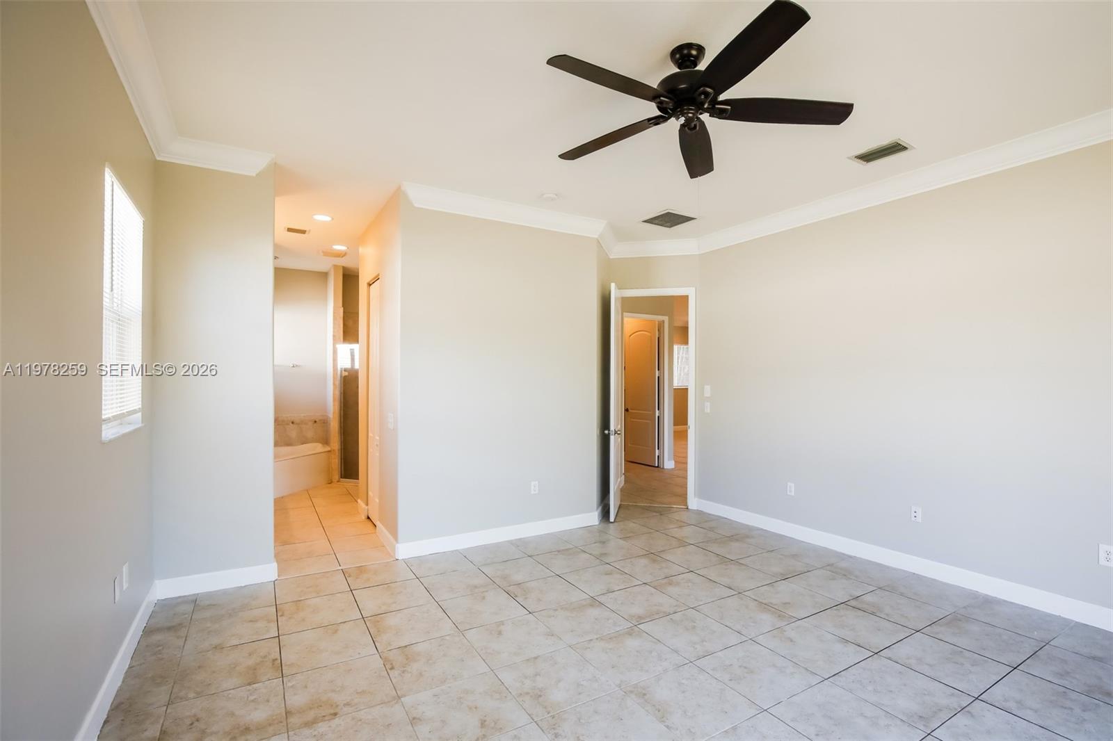 18686 Southwest 132nd Avenue Miami, FL 33177 - Photo 12 of 18 a view of an empty room and a ceiling fan
