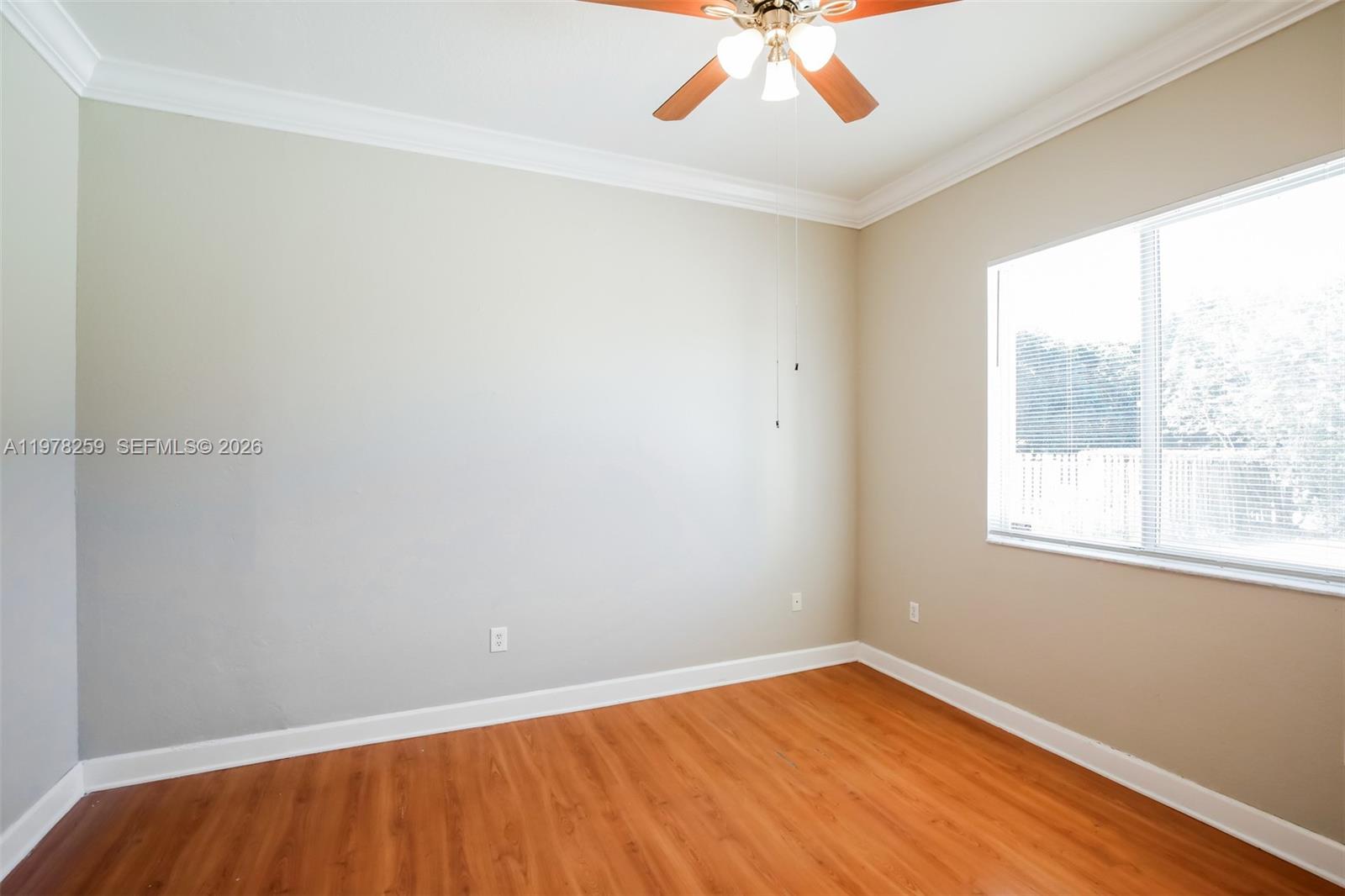 18686 Southwest 132nd Avenue Miami, FL 33177 - Photo 13 of 18 wooden floor in an empty room with a window