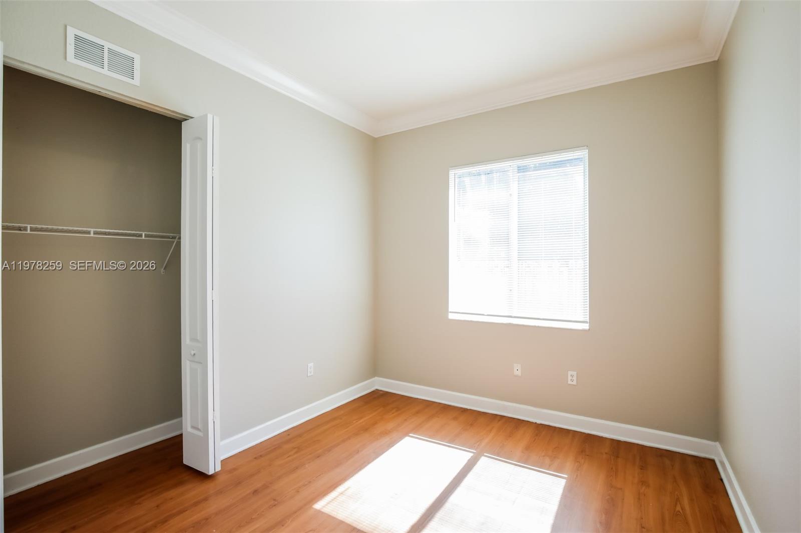 18686 Southwest 132nd Avenue Miami, FL 33177 - Photo 14 of 18 an empty room with wooden floor and windows