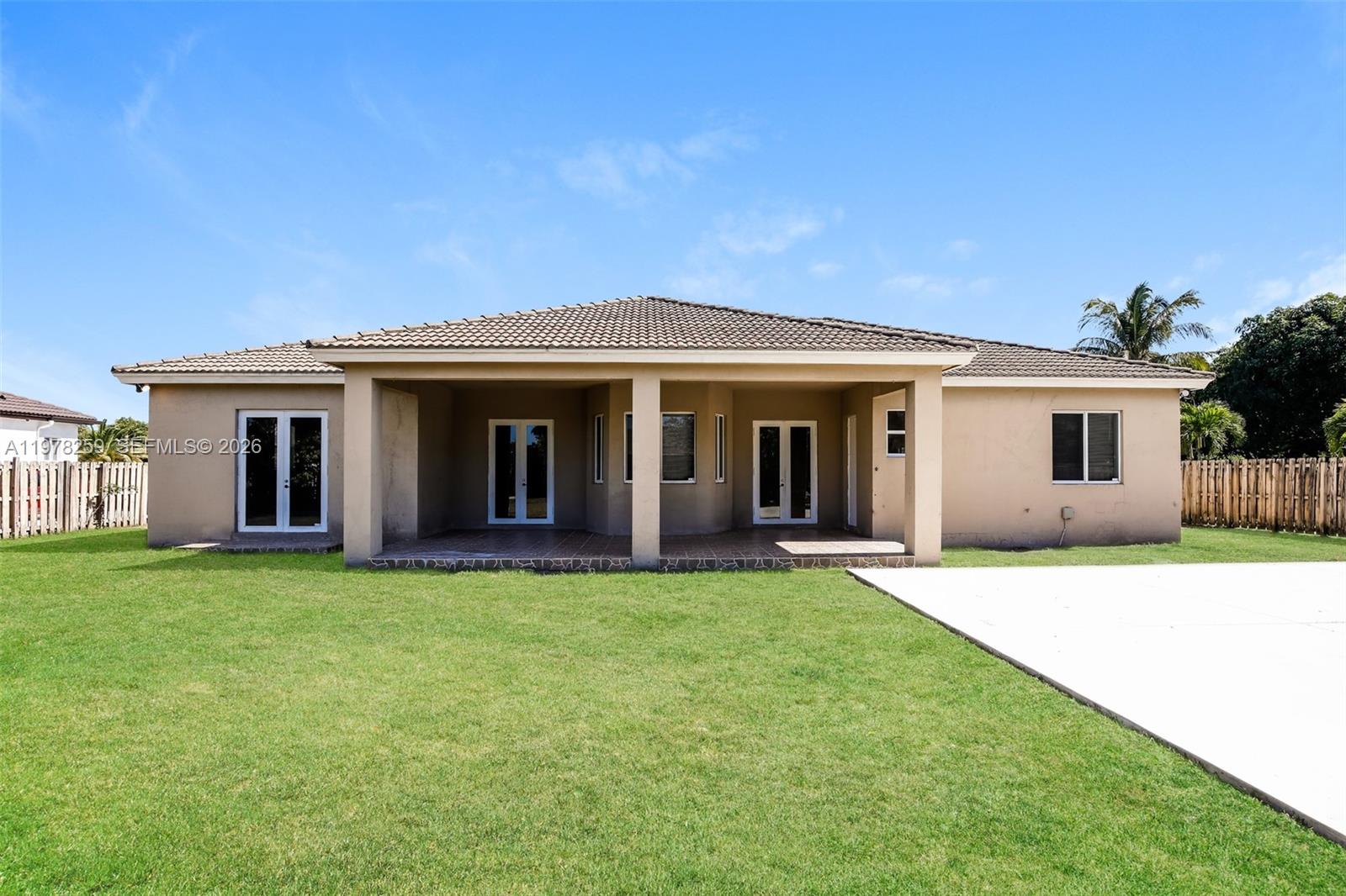 18686 Southwest 132nd Avenue Miami, FL 33177 - Photo 18 of 18 a front view of a house with a garden