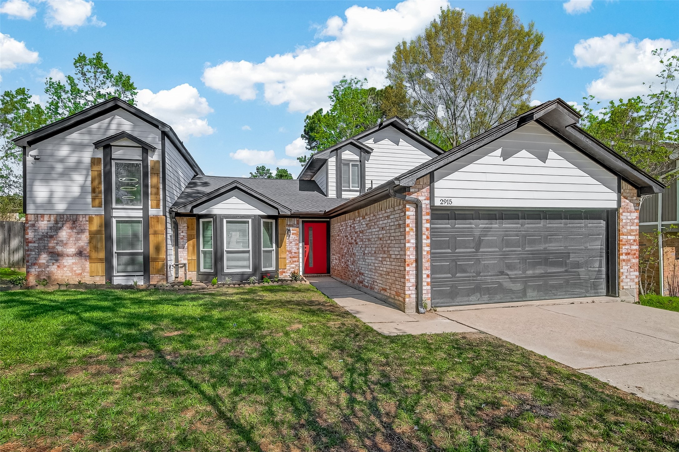 2915 Whispering Springs Drive Spring, TX 77373 - Photo 1 of 36 Beautifully updated two-story home featuring modern curb appeal, fresh landscaping potential, and a bold statement front door.
