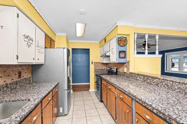 a kitchen with stainless steel appliances granite countertop a sink and cabinets