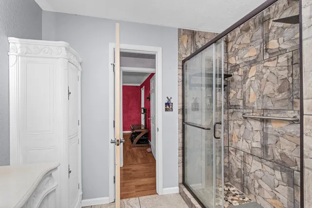 a bathroom with a shower and a sink