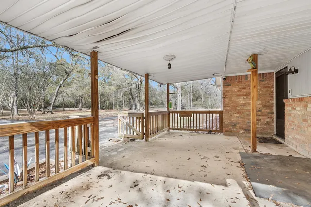 a view of a porch with wooden floor and windows