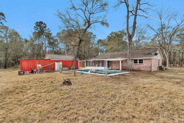 a view of green field with house in the background