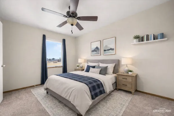 a bedroom with a large bed and a ceiling fan