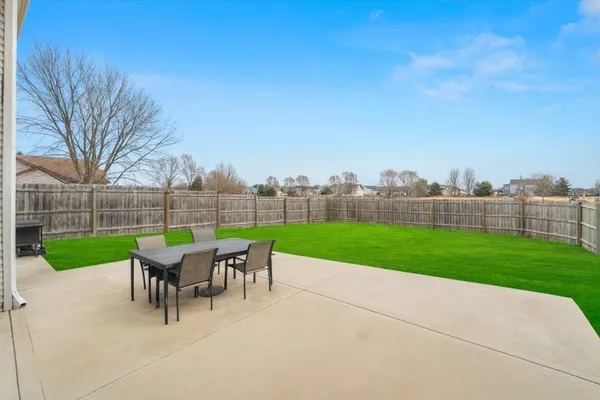 a view of a house with a backyard porch and sitting area