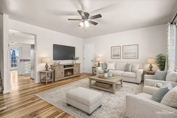 a living room with furniture a fireplace and a flat screen tv