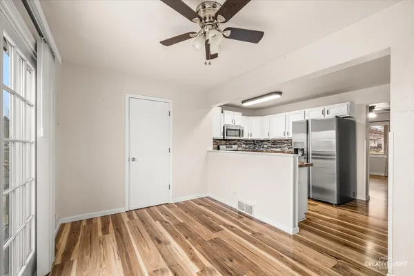 a view of a kitchen with a sink and refrigerator