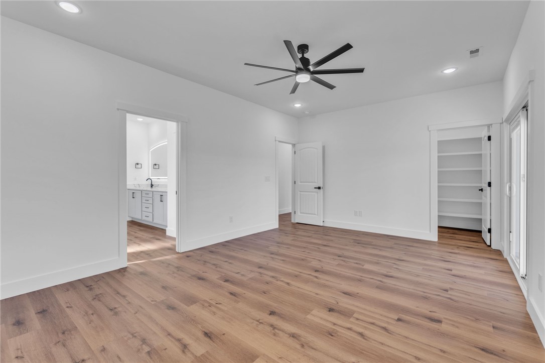 1723 Harris Bridge Road Anderson, SC 29621 - Photo 13 of 33 A naturally illuminated primary bedroom offers rich wood flooring and a refreshing ceiling fan.