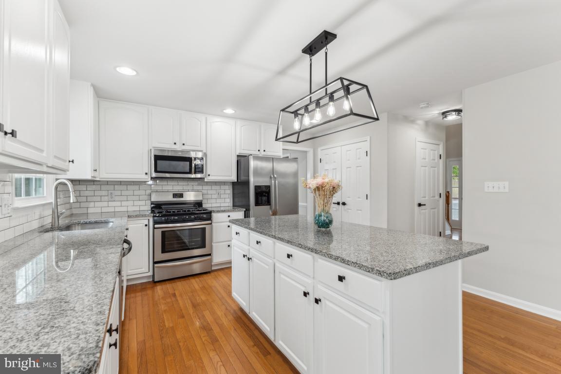 5 Basalt Drive Fredericksburg, VA 22406 - Photo 18 of 41 a kitchen with stainless steel appliances granite countertop a sink refrigerator stove and microwave