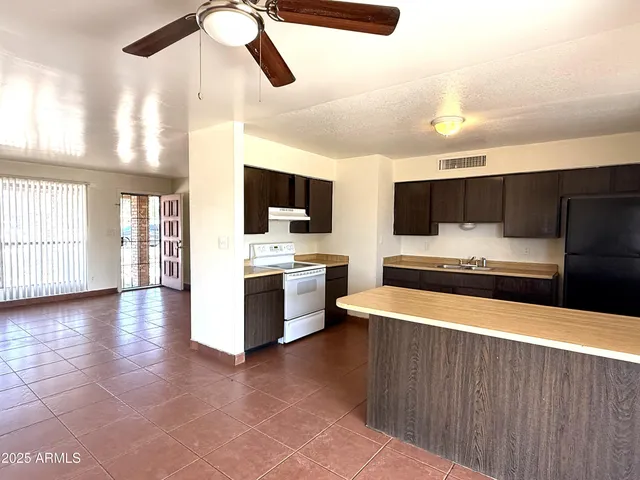 a large kitchen with a large counter top appliances and cabinets