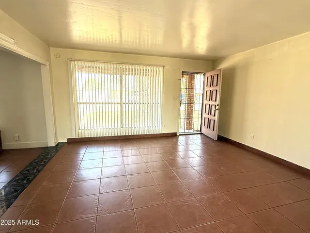 a view of an empty room with a window