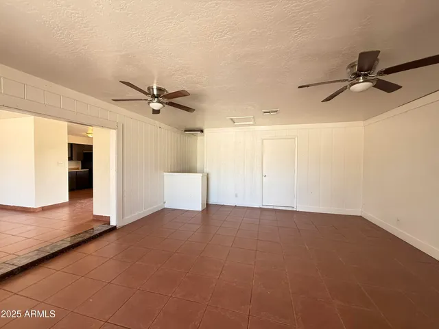 a view of a livingroom with a ceiling fan and wooden floor