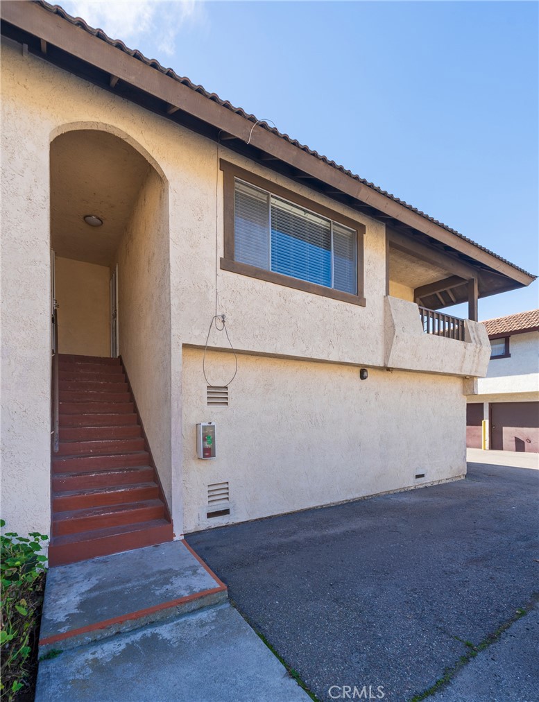 2155 Canyon Drive, Unit D Costa Mesa, CA 92627 - Photo 1 of 27 a front view of a house with wooden stairs