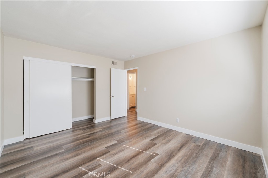 2155 Canyon Drive, Unit D Costa Mesa, CA 92627 - Photo 16 of 27 a view of an empty room and wooden floor