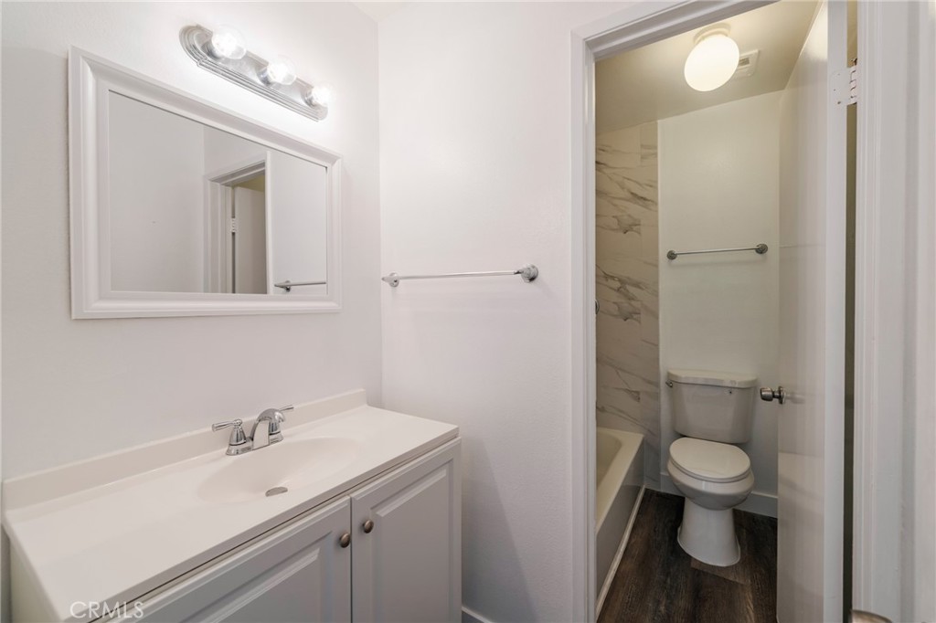2155 Canyon Drive, Unit D Costa Mesa, CA 92627 - Photo 17 of 27 a bathroom with a sink a toilet and shower