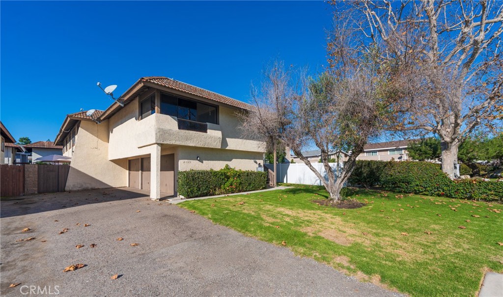 2155 Canyon Drive, Unit D Costa Mesa, CA 92627 - Photo 4 of 27 a front view of a house with a yard