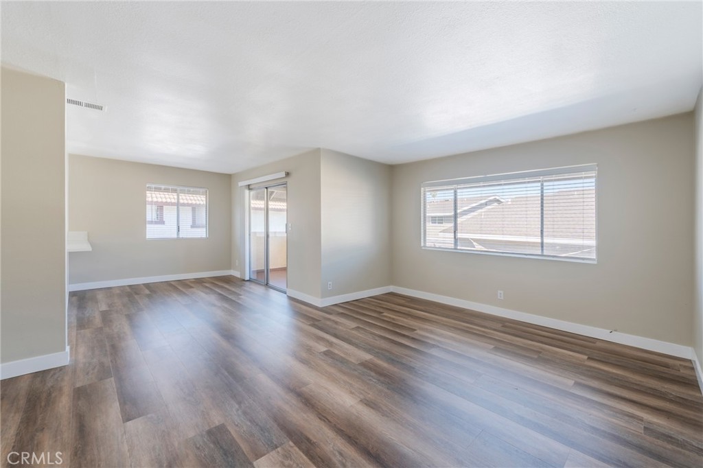 2155 Canyon Drive, Unit D Costa Mesa, CA 92627 - Photo 6 of 27 a view of an empty room with wooden floor and window