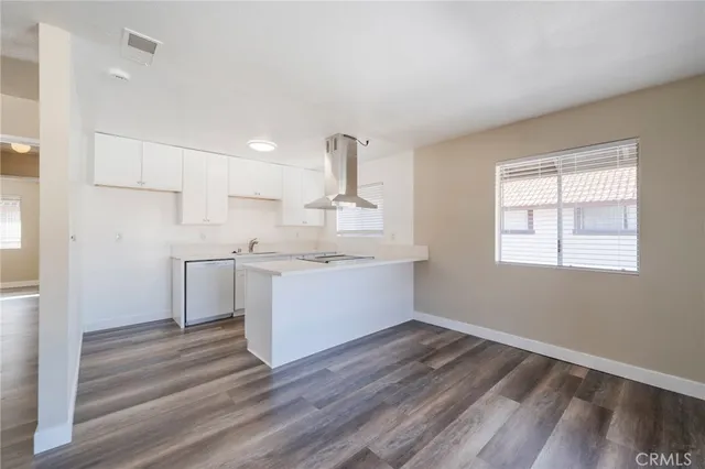 a kitchen with a sink cabinets stainless steel appliances and a window